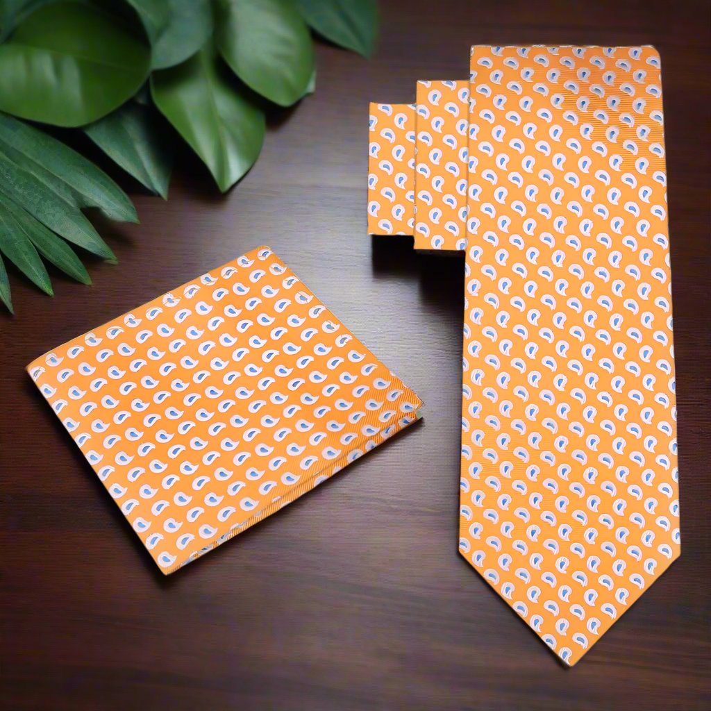Close-up of vibrant paisley silk necktie with orange, white, and blue hues for formal wear