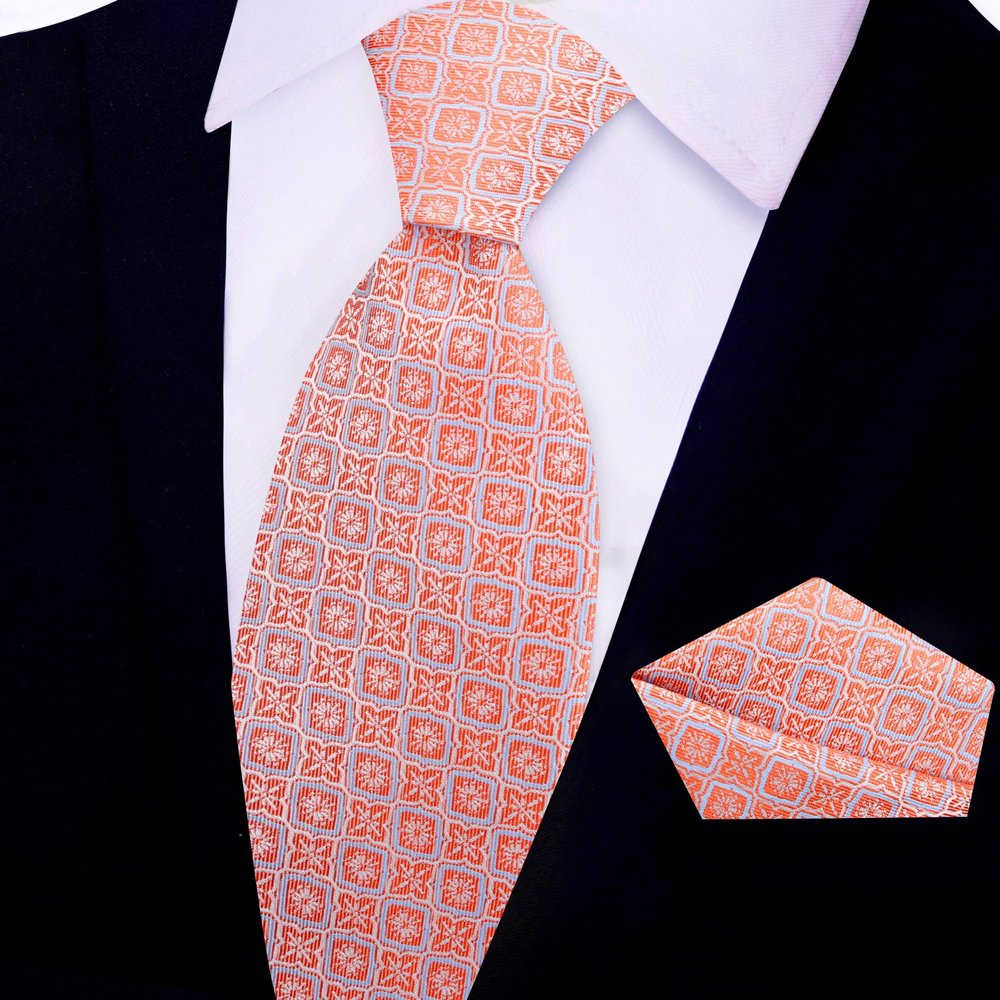 Close-up of geometric pattern silk necktie in peach pink on a display mannequin
