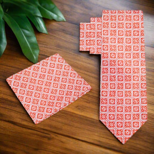 Silk necktie in peach pink with modern geometric design paired with formal suit