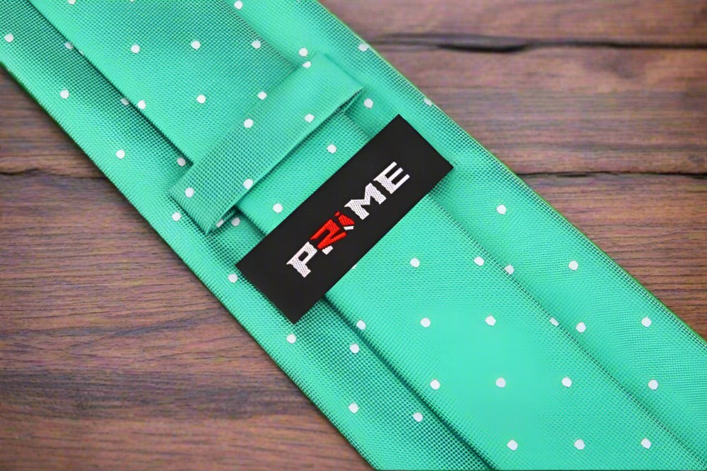 Close-up of vibrant green silk tie with white polka dots, perfect for weddings.