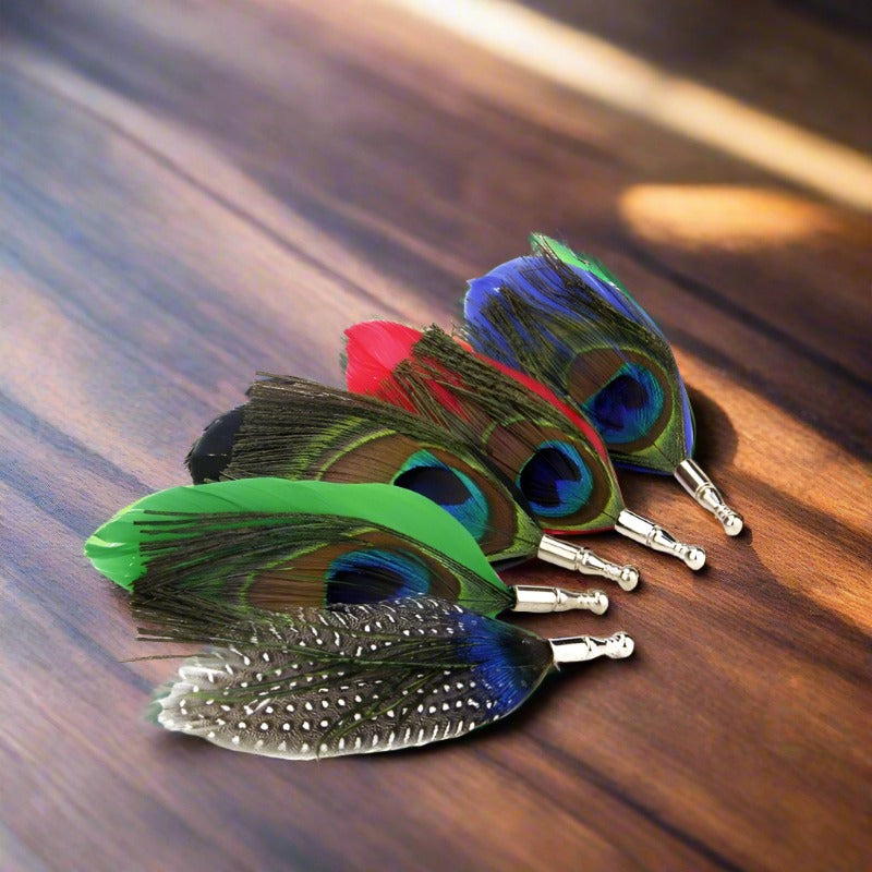 Close-up of the gold peacock lapel pin highlighting its detailed craftsmanship.
