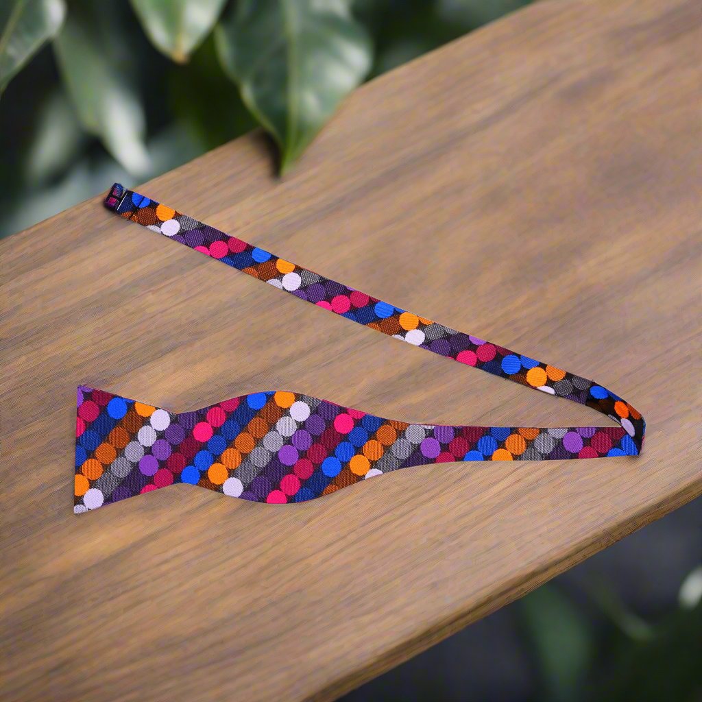 Flat lay of bow tie and matching pocket square, showcasing colorful polka dot pattern and silk texture