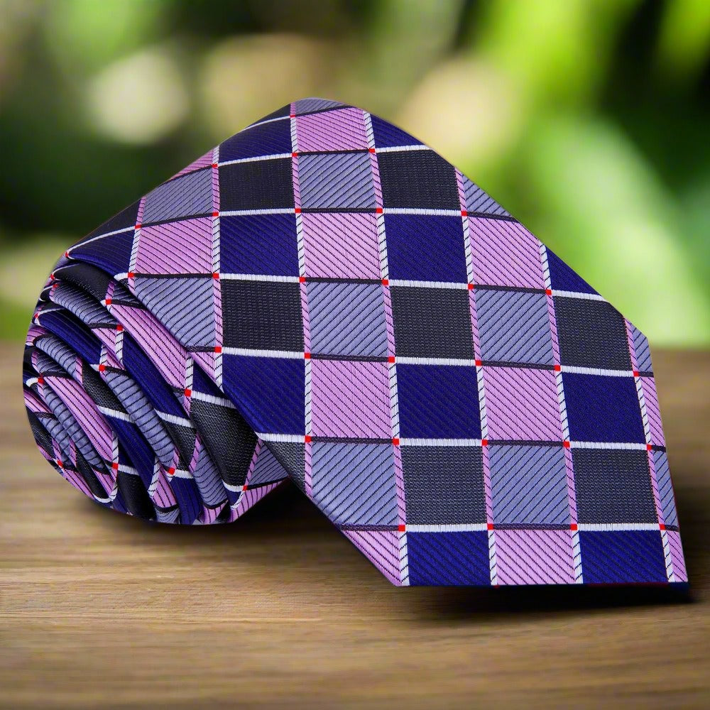 Man adjusting his formal silk tie with coordinating pocket square for wedding attire