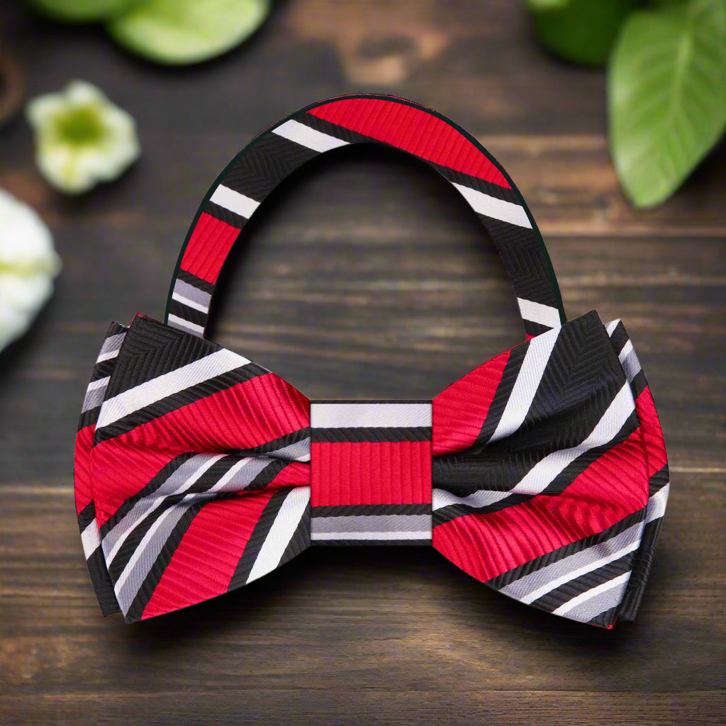 Close-up of the dynamic stripe pattern on the red, black, and white silk bow tie.
