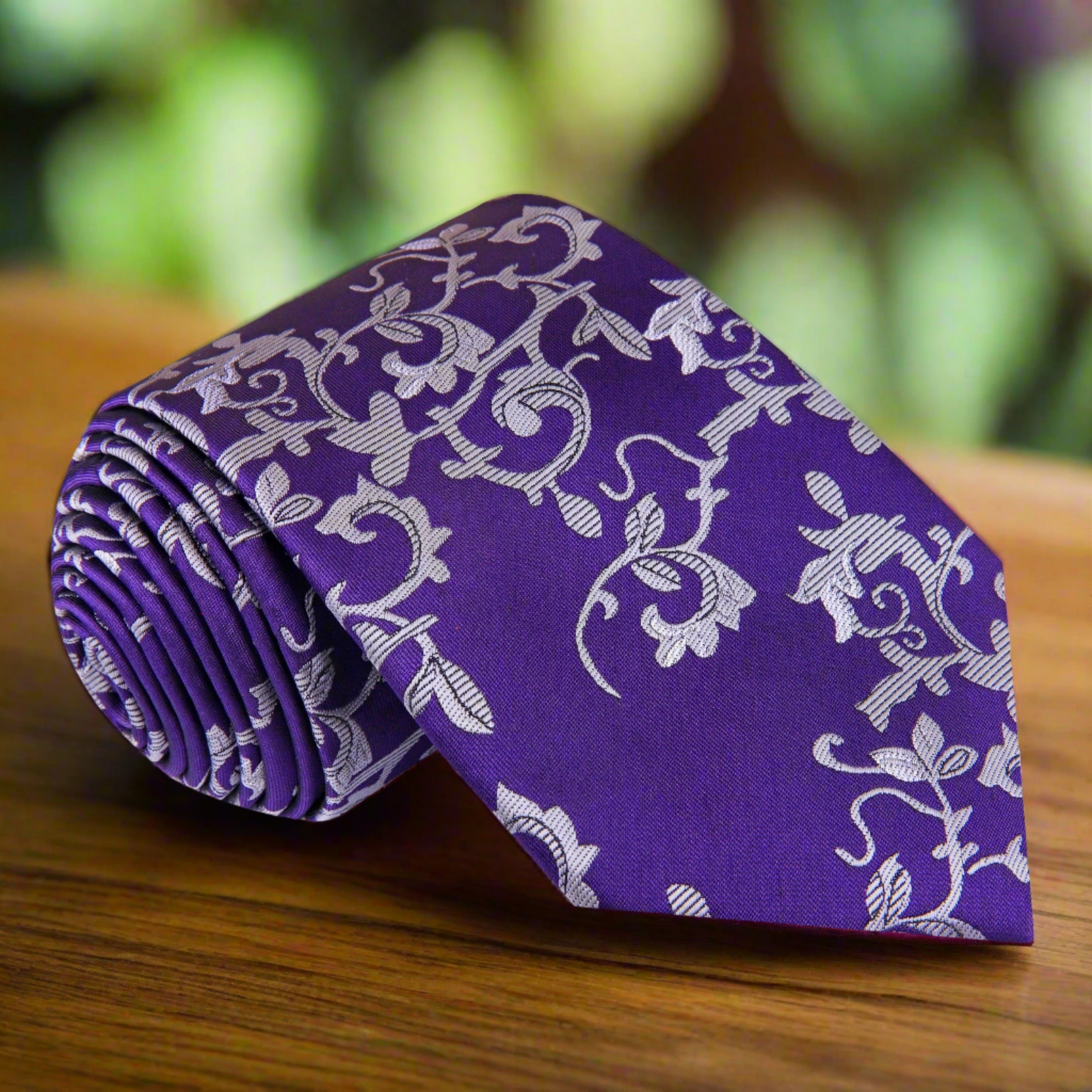 Close-up of Odyssey floral necktie with purple and grey vines pattern