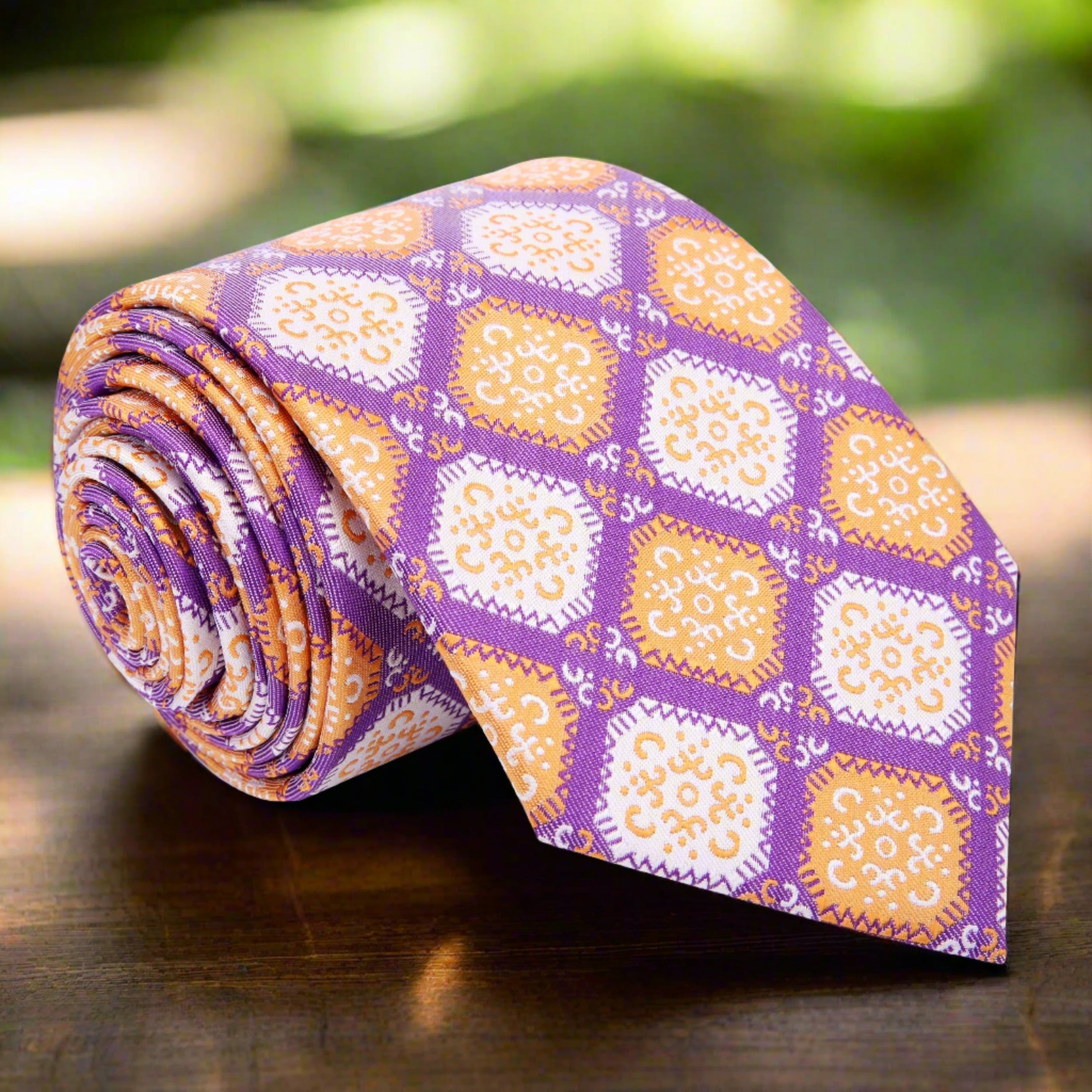 Front view of geometric tie with large diamond pattern in purple, orange, and cream