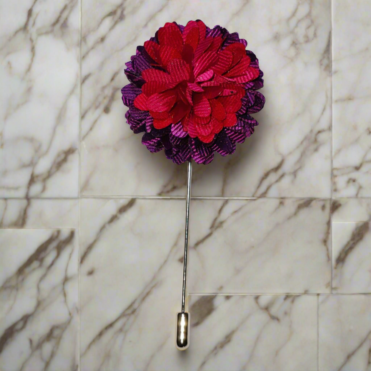 Close-up of purple and red flower lapel pin showing detailed craftsmanship