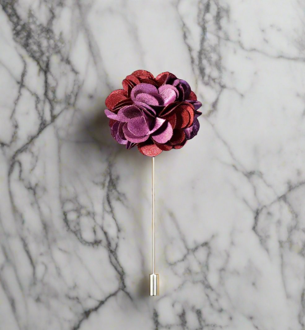 Close-up of colorful leaf lapel pin on jacket, highlighting vibrant colors and detailed design