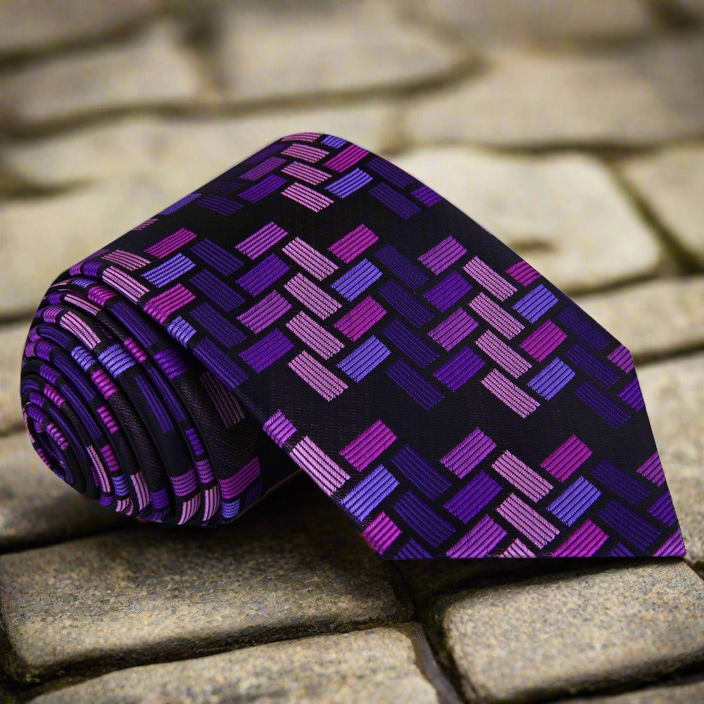 Close-up of the purple silk tie showcasing its intricate jigsaw geometric pattern.