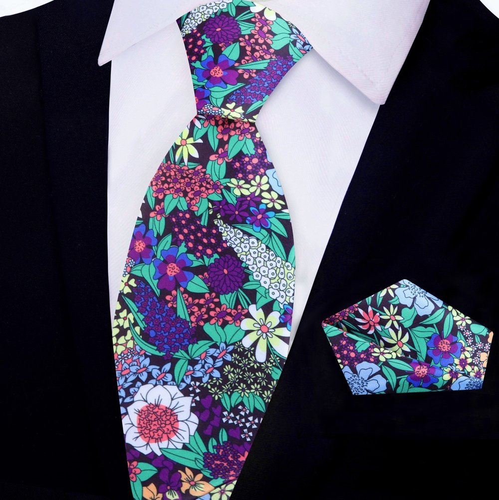 Man wearing floral necktie with a white dress shirt at outdoor wedding