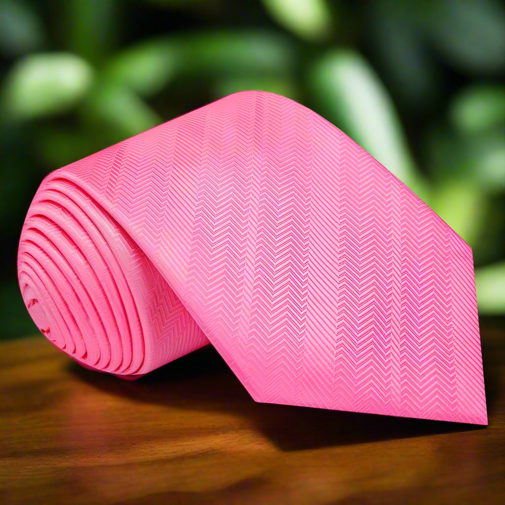 Elegant pink silk necktie displayed on a white dress shirt, showcasing the lined texture.