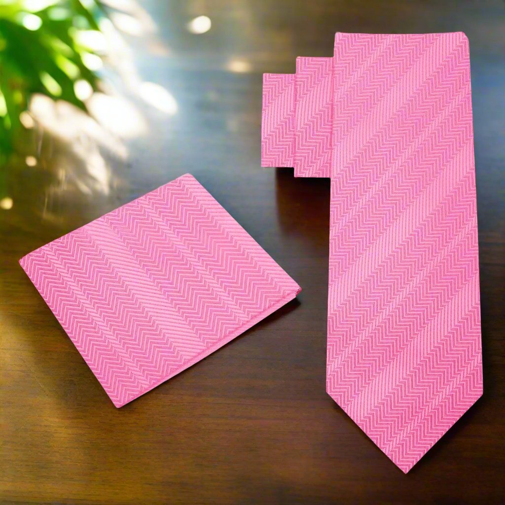 Elegant pink silk necktie displayed on a white dress shirt, showcasing the lined texture.