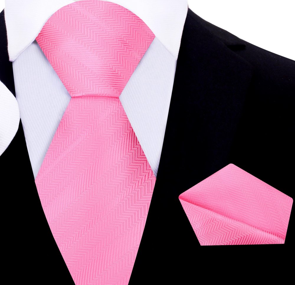 Pocket square matching the pink and purple silk necktie, elegantly folded on a polished wooden surface.
