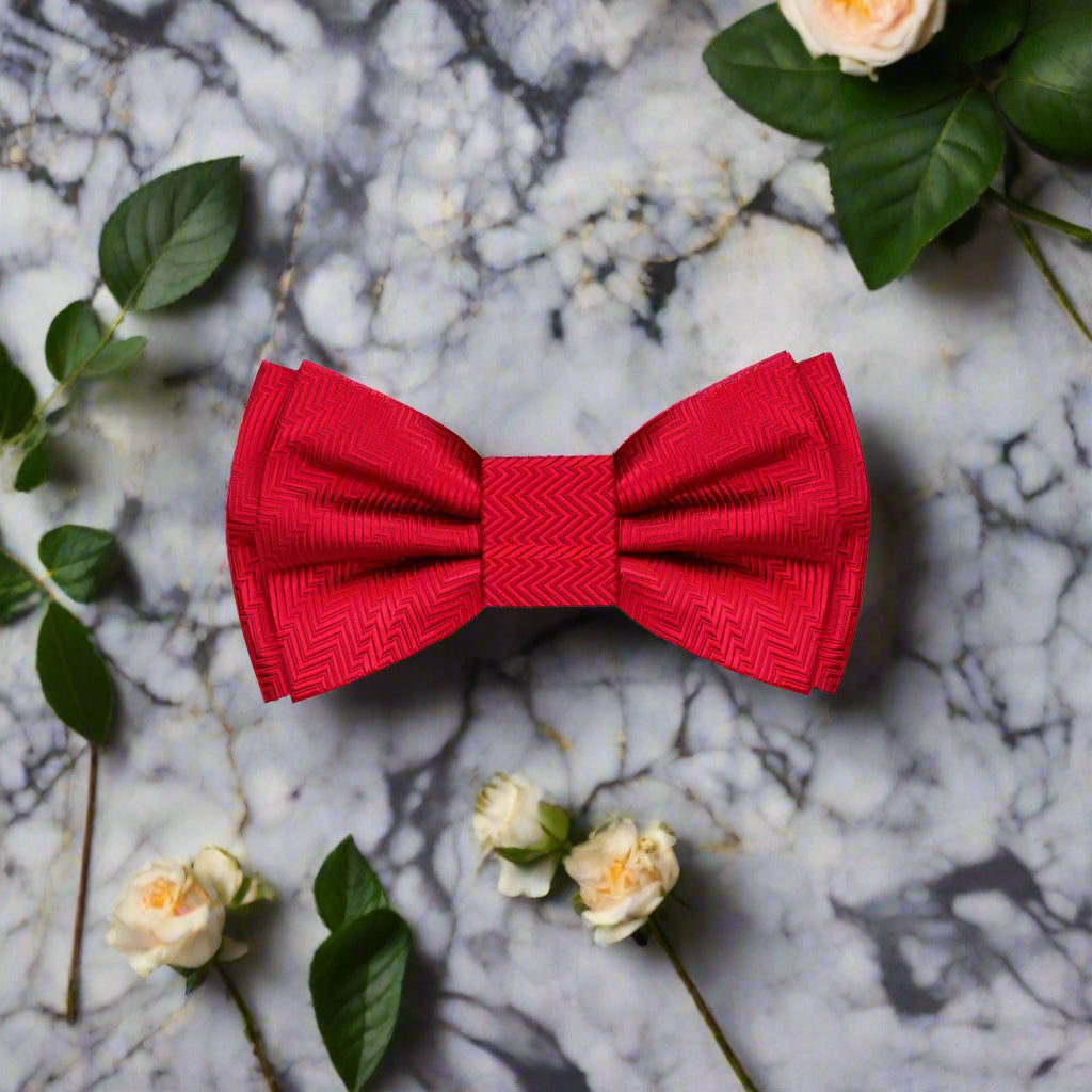 Close-up of the garnet red silk bow tie showing its luxurious fabric and solid lined texture.