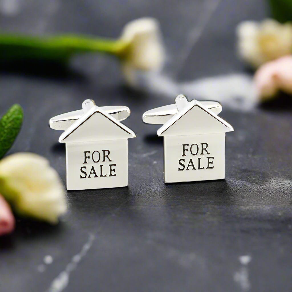 Close-up view of Real Estate Charm Cufflinks showcasing chrome finish and house shape