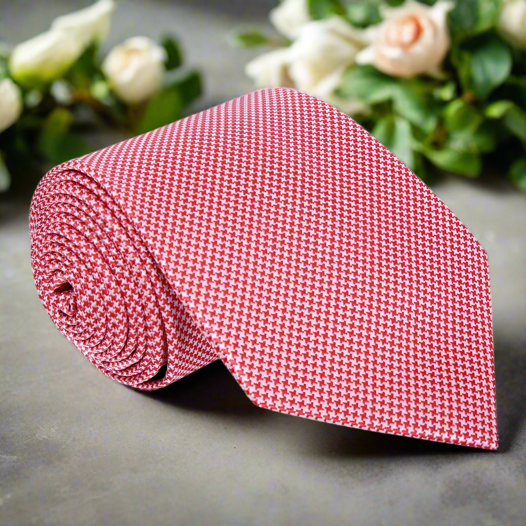 Close-up of the Xerxes silk necktie in red houndstooth pattern paired with a white dress shirt.