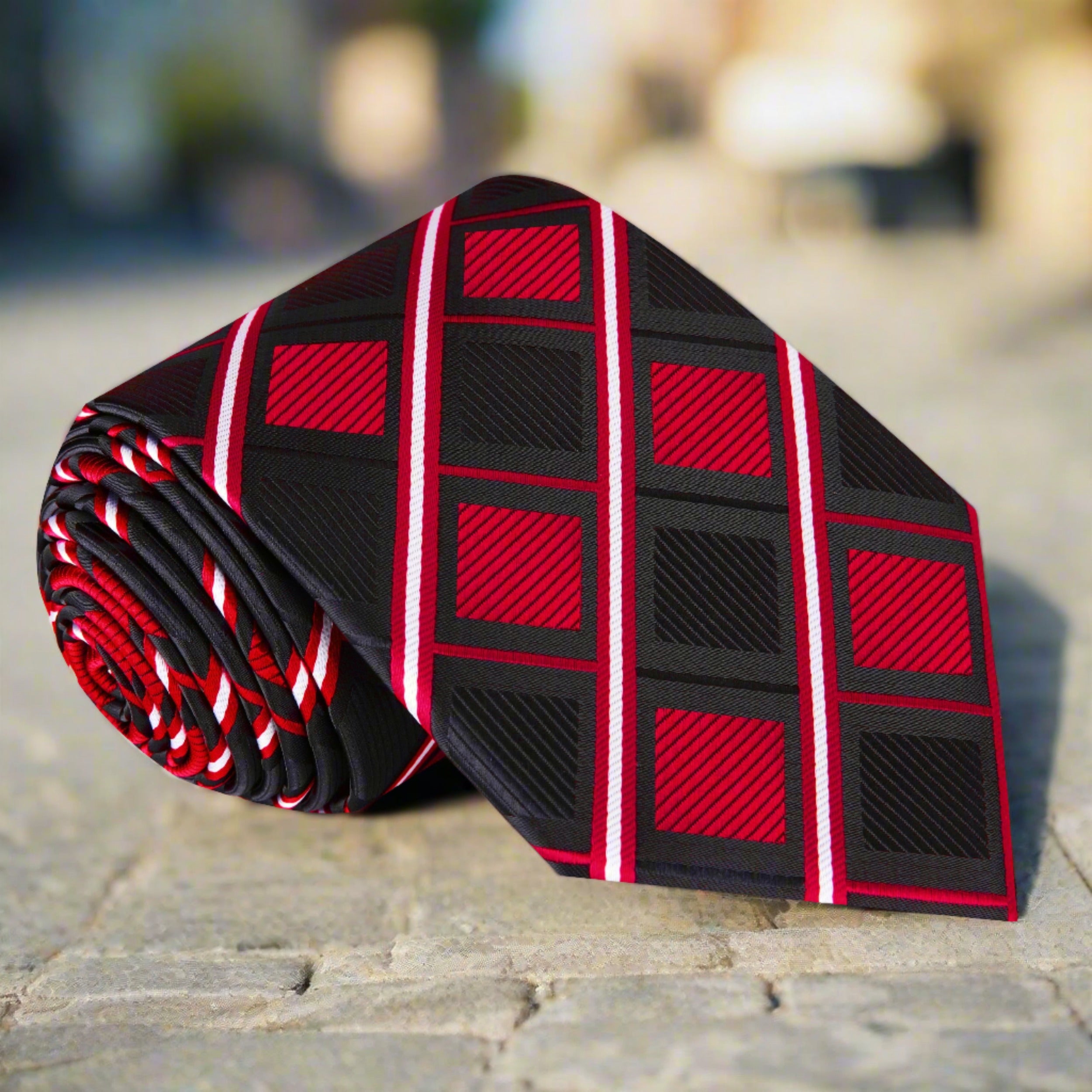 Close-up of a men's silk geometric tie in red and black, perfect for weddings