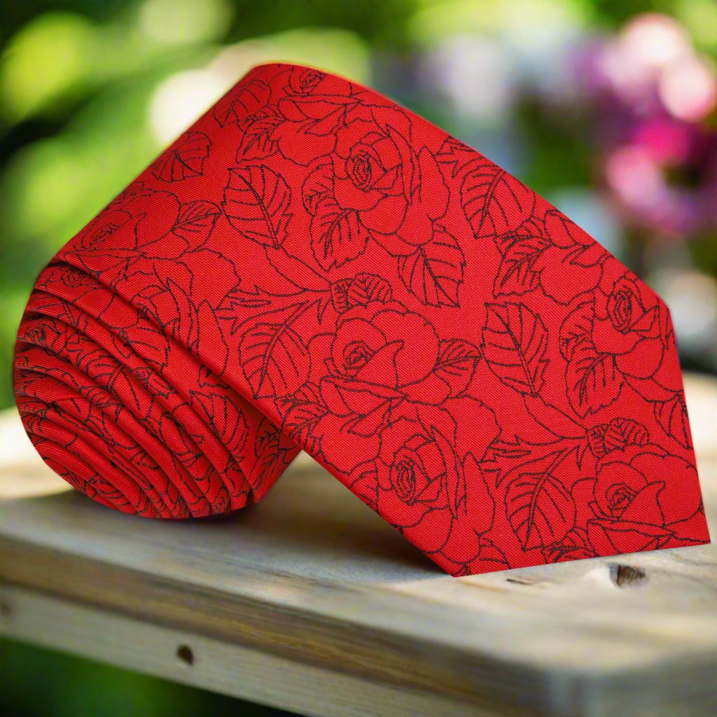 Elegant red and black silk tie with sketched roses pattern, showcasing its luxurious fabric and design.