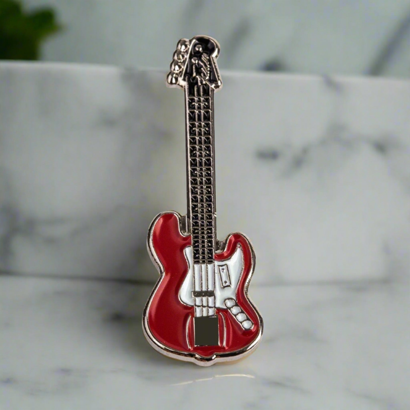 Close-up of the premium guitar lapel pin in blue pearl finish
