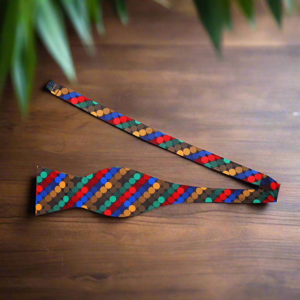 Flat lay of bow tie and matching pocket square, showcasing colorful polka dot pattern and silk texture