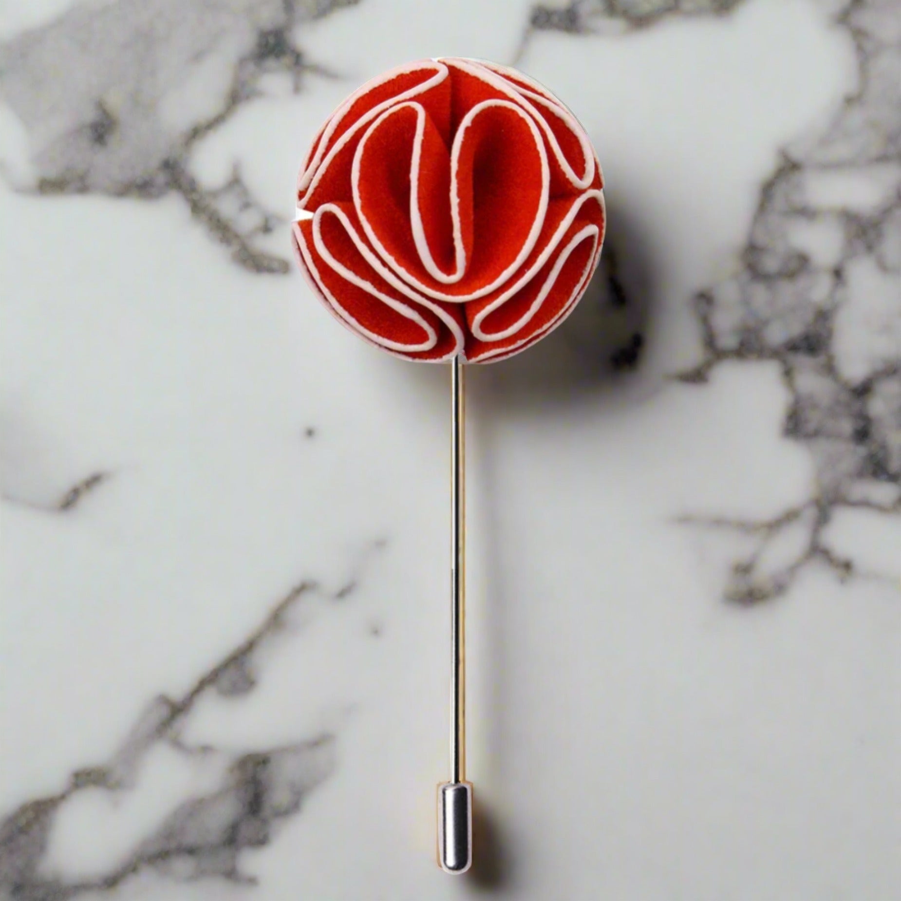 Close-up of the elegant custom flower lapel pin in burgundy and yellow.