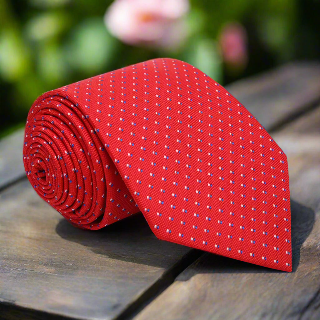 Close-up of Monte Carlo polka dot silk necktie showing small white dots on vibrant red fabric