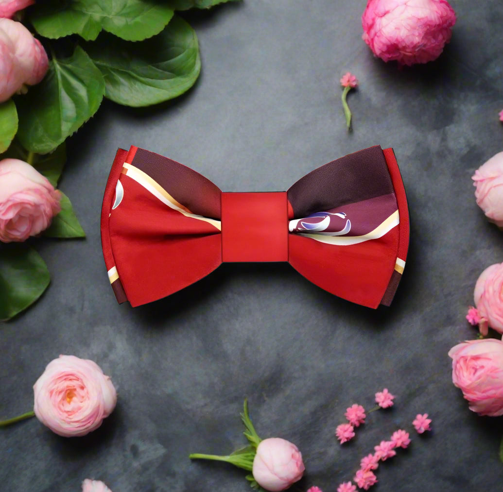 Front view of the vibrant red and gold swirling bow tie, showcasing intricate patterns.