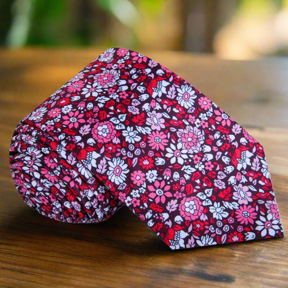 Close-up of the elegant green floral silk tie showcasing intricate floral patterns.