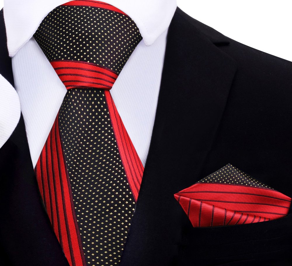 Elegant red, black, and gold silk necktie displayed on a white shirt, showcasing its abstract design.