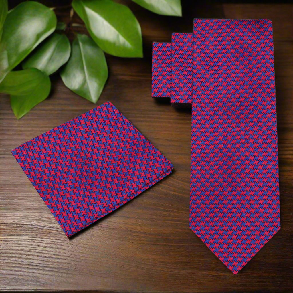 Elegant red and blue houndstooth silk tie on a white background.
