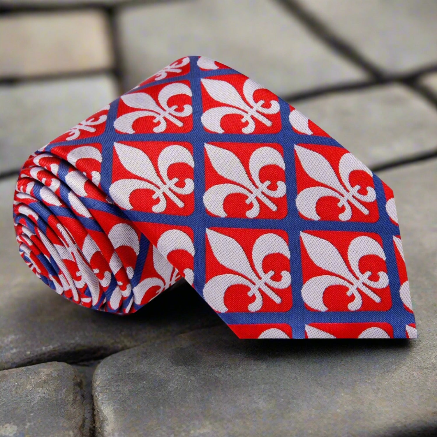 Fleur-de-lis necktie in red, blue, and grey, featuring geometric patterns.