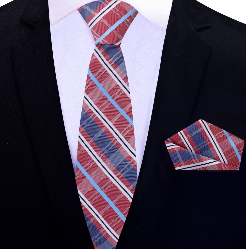 Man wearing a plaid silk necktie with a white dress shirt and navy blazer at a wedding