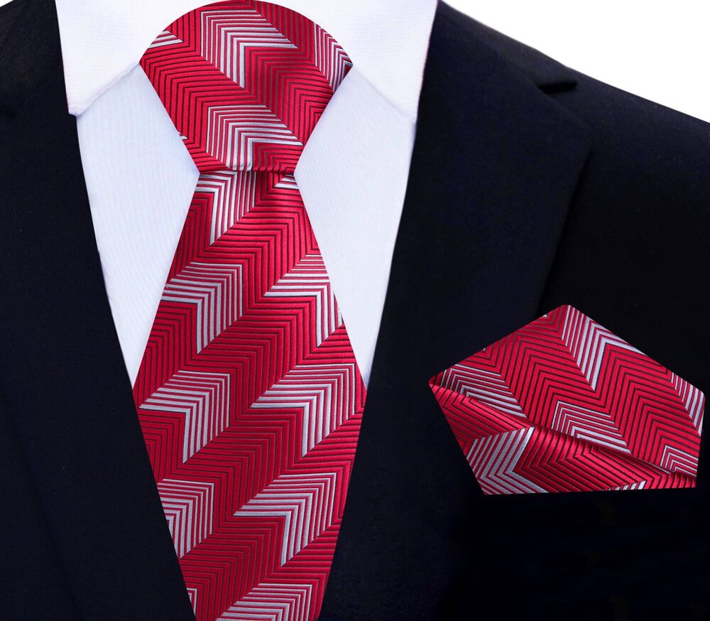 Close-up of Dynamic Chevron Necktie showcasing the geometric design in Dark Blue with Light Grey.