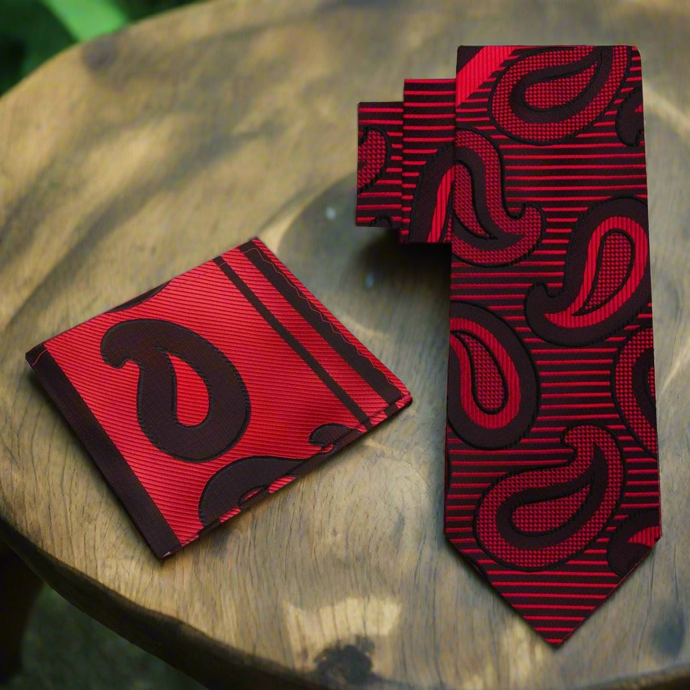 Close-up of a large paisley pattern silk necktie in dark red and black