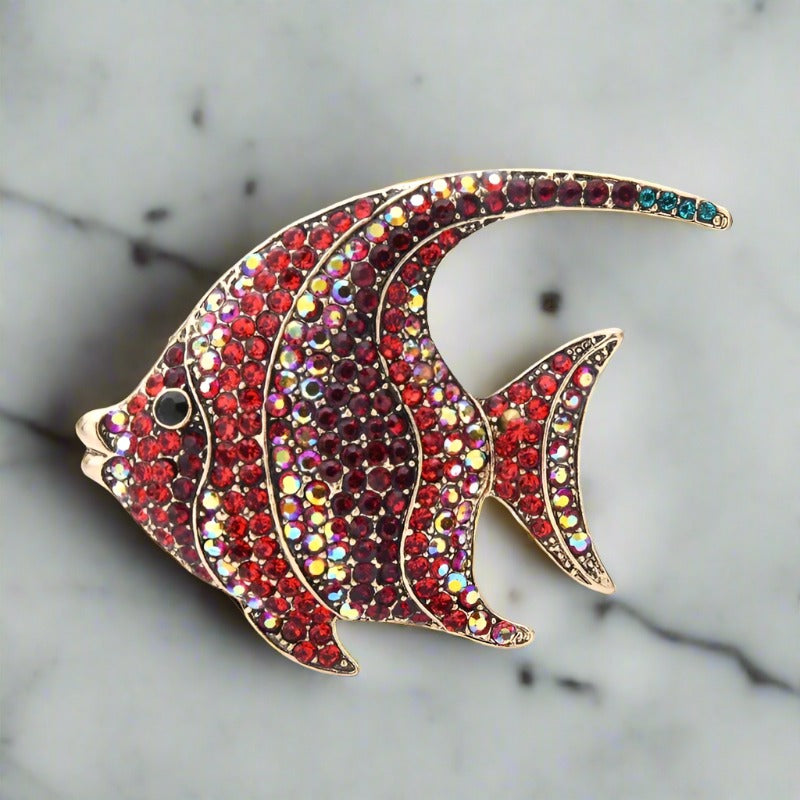 Colorful exotic animal pins with gemstones displayed for gift ideas