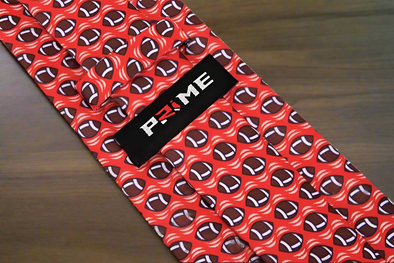 Blue necktie featuring playful brown footballs, perfect for sports events.