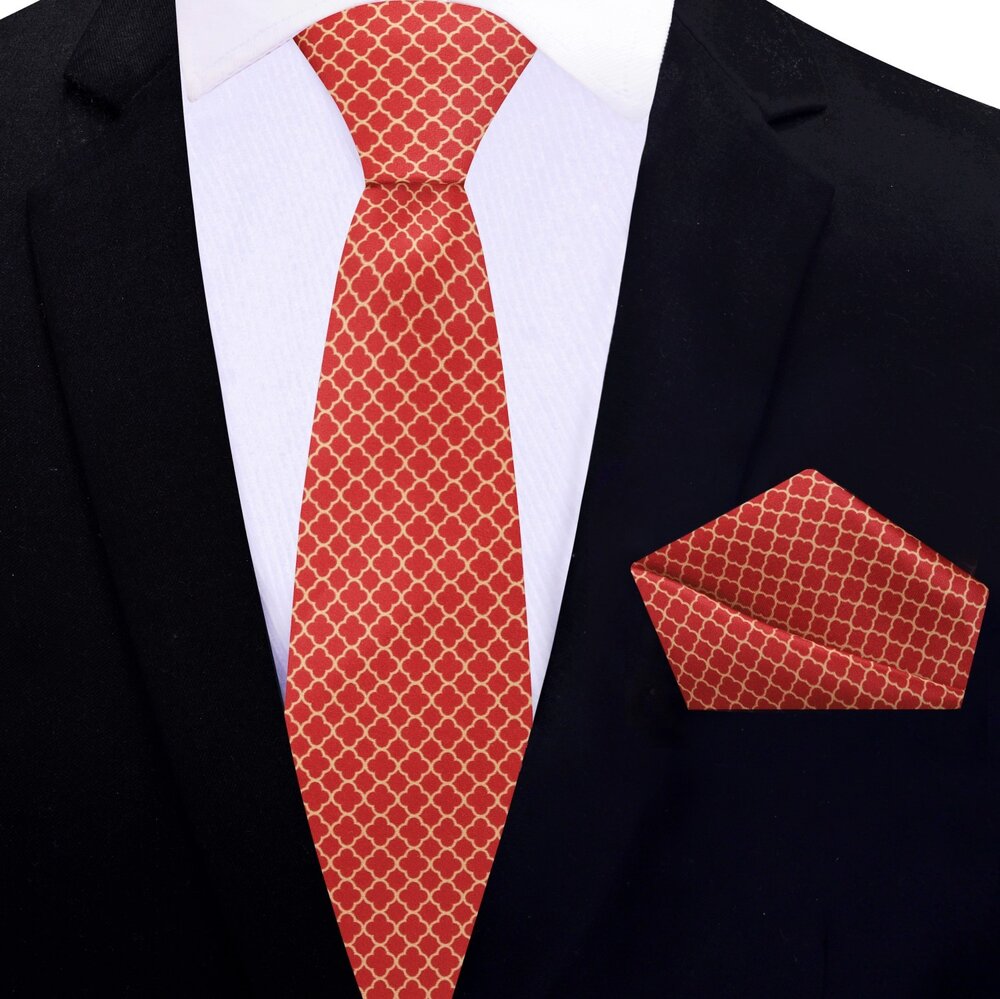 Red quatrefoil necktie with gold pattern displayed on a mannequin for wedding attire