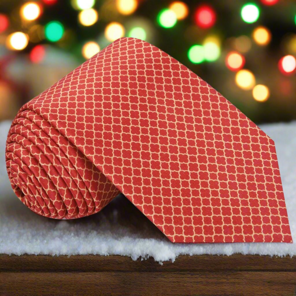 Red quatrefoil necktie with gold pattern displayed on a mannequin for wedding attire