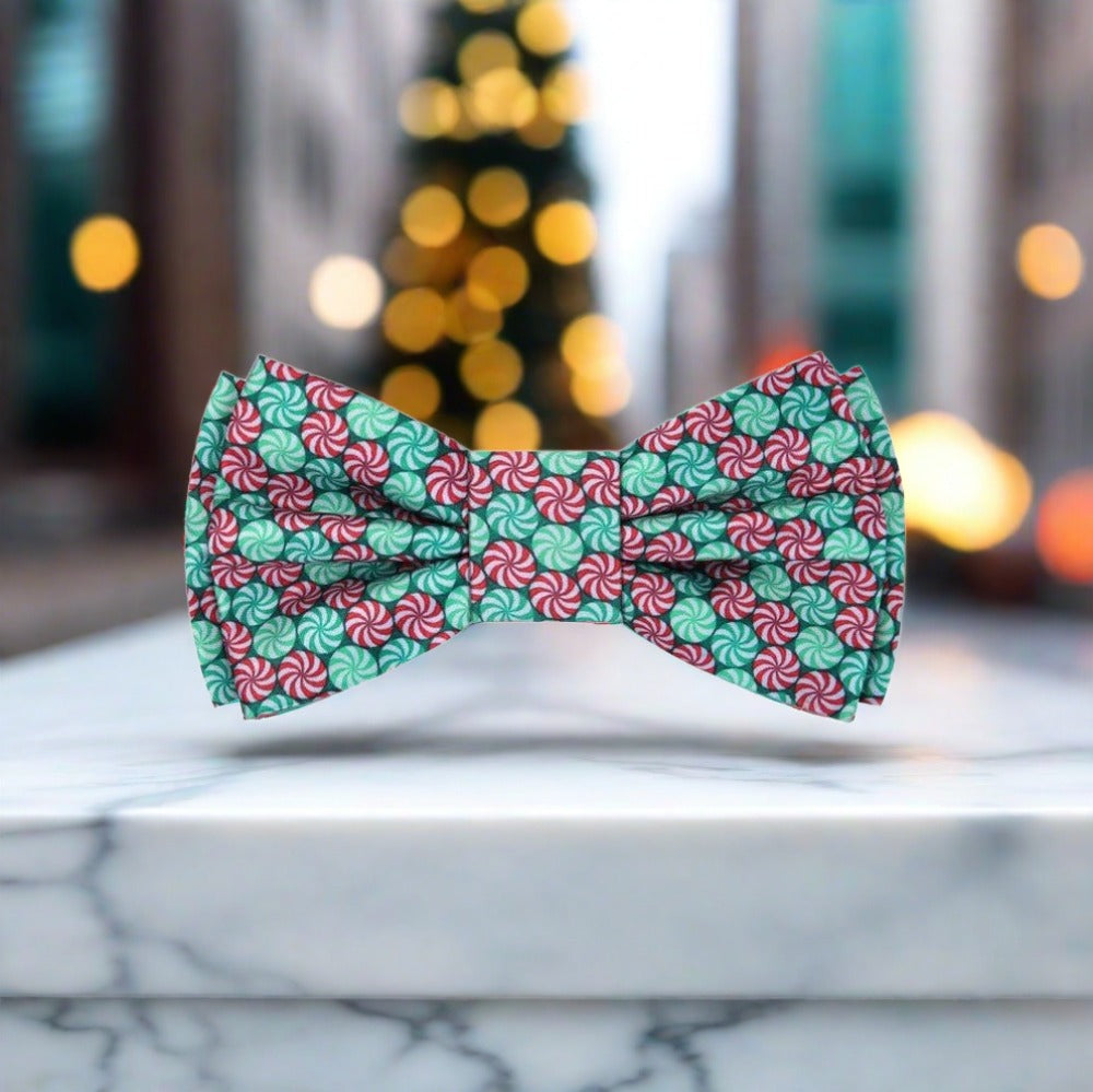 Man wearing Christmas Candy Bow Tie with navy suit at holiday party