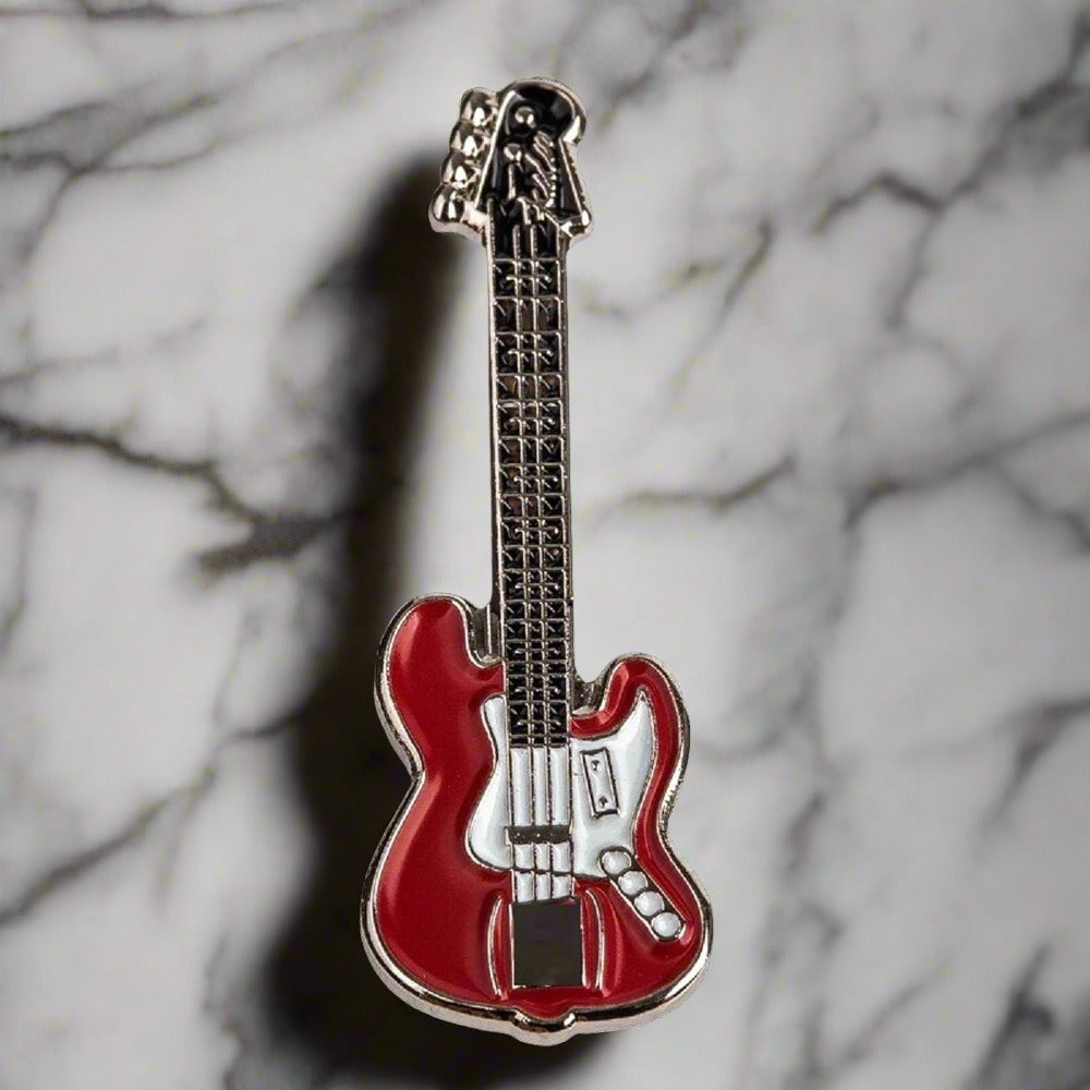 Collection of different guitar lapel pins in various colors