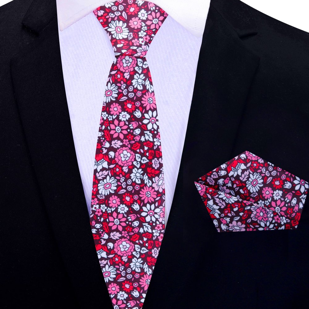 Model wearing a floral silk necktie with a white dress shirt and navy suit