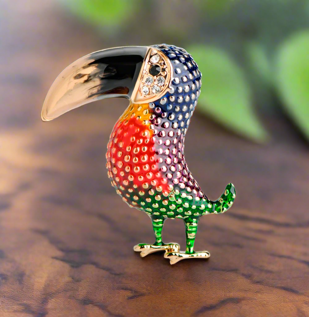 Colorful toucan lapel pin against a white dress shirt, showcasing the vibrant details.