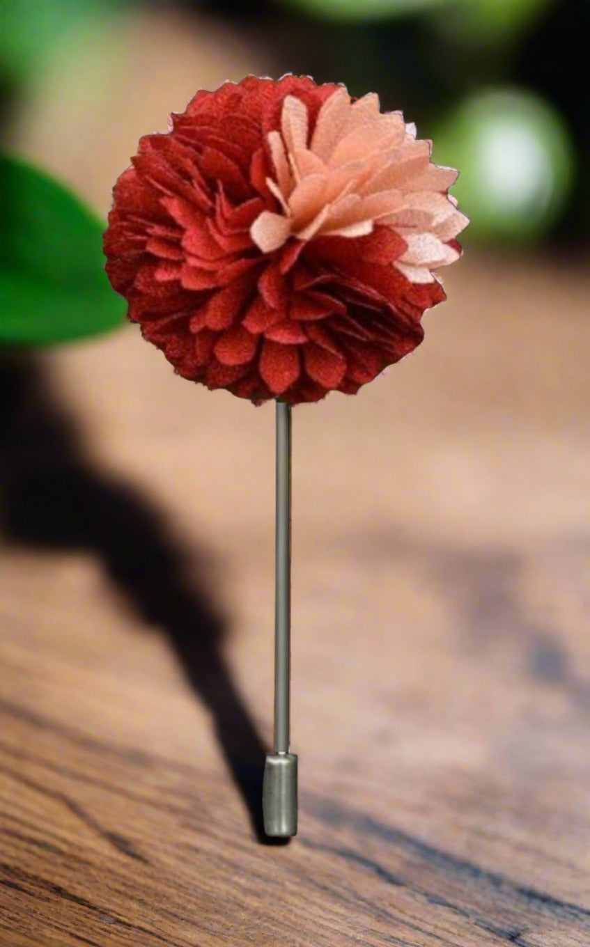 Close-up of mens flower petal lapel pin in red and black, showcasing intricate petal design.