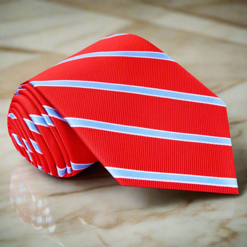 Close-up of the designer striped silk tie with vivid red and light blue stripes, highlighting its luxurious texture.