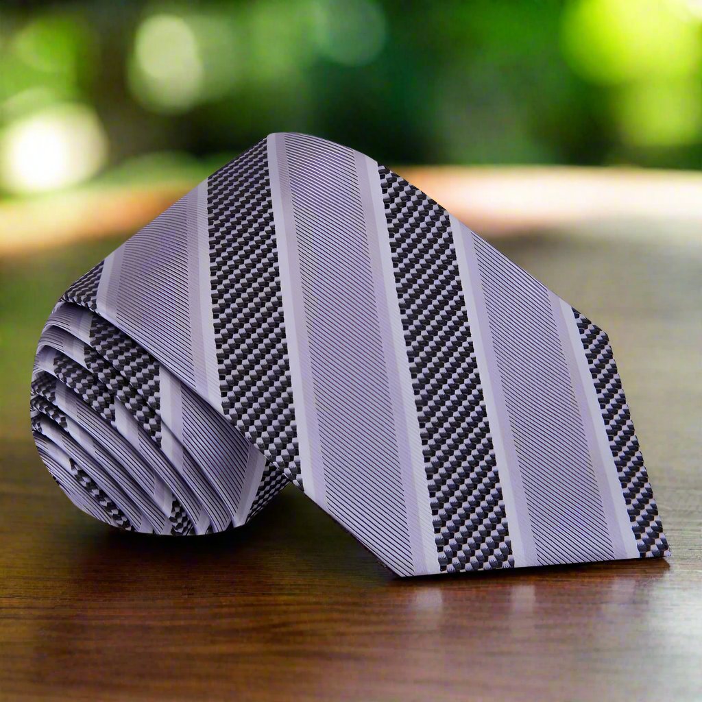 Close-up of classic blue striped silk necktie set on a dark background, showcasing its luxurious texture.