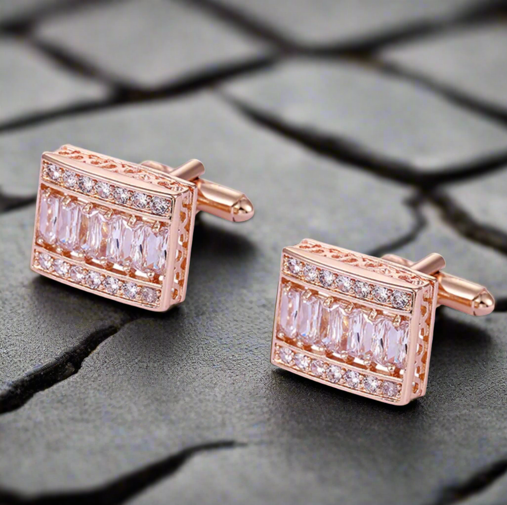Elegant rose gold cufflinks with clear stones on a white dress shirt