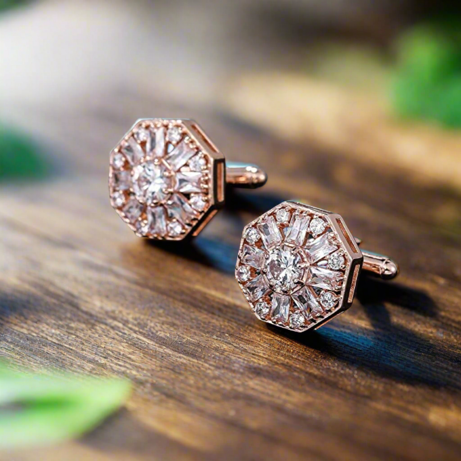 Rose gold octagon cufflinks displayed on a black suit fabric, showcasing elegance.