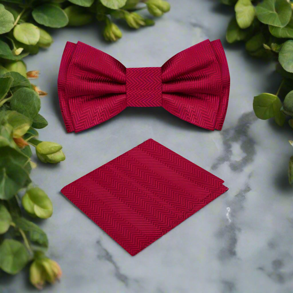 Close-up of the garnet red silk bow tie showing its luxurious fabric and solid lined texture.