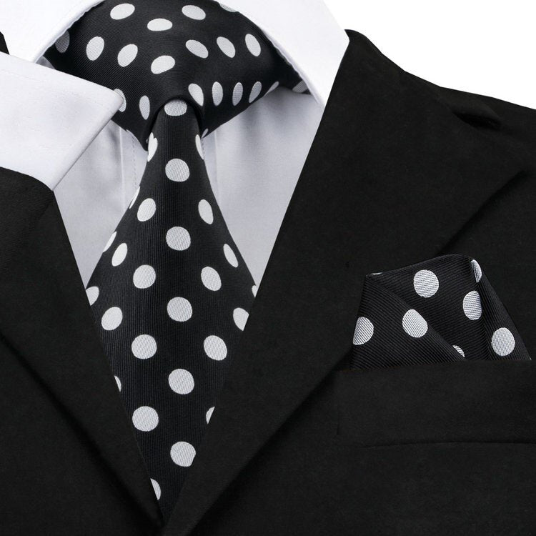 Children's silk necktie and pocket square set displayed on a wooden table, showcasing the polka dot design.