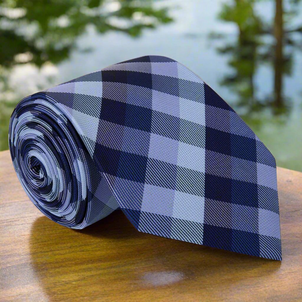 Blue plaid necktie displayed on a white dress shirt, showcasing its elegant design.